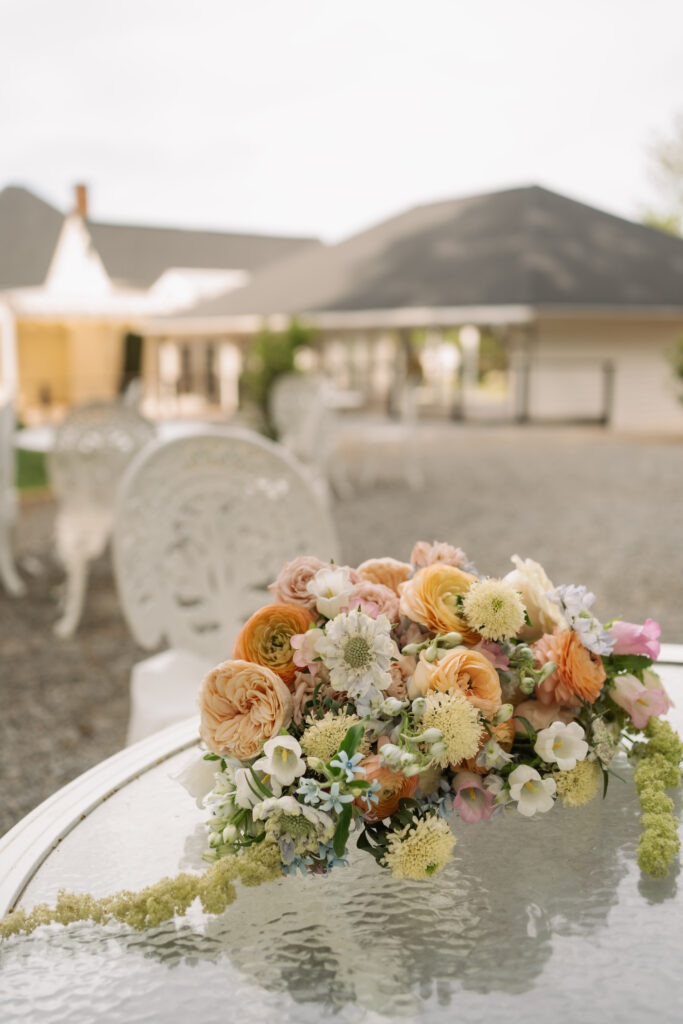Wedding bouquet detail photo with peach and ivory florals during bridal portraits.