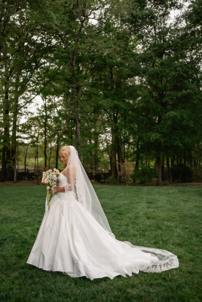 Elegant outdoor bridal portrait showing bride in long veil during pre-wedding session.
